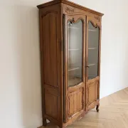 Antique display cabinet in Louis XV style made of wood.