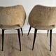 Pair of vintage barrel chairs in boucle fabric with brass splayed legs.