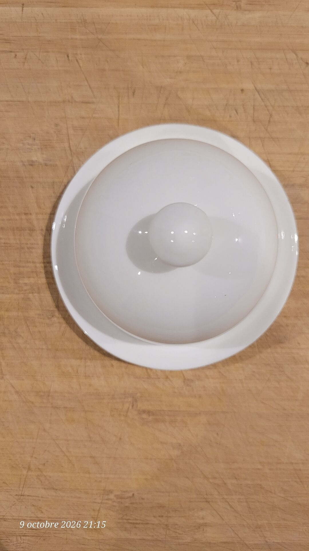 White porcelain butter dish accompanied by its matching bell.