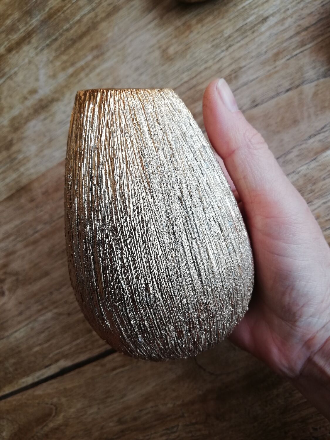 Small asymmetrical golden seed-shaped vase