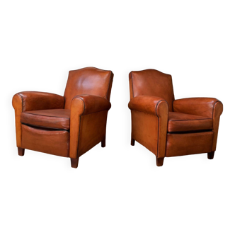 Pair french leather club chairs, chapeau de gendarme models, circa 1930, in a rich carame