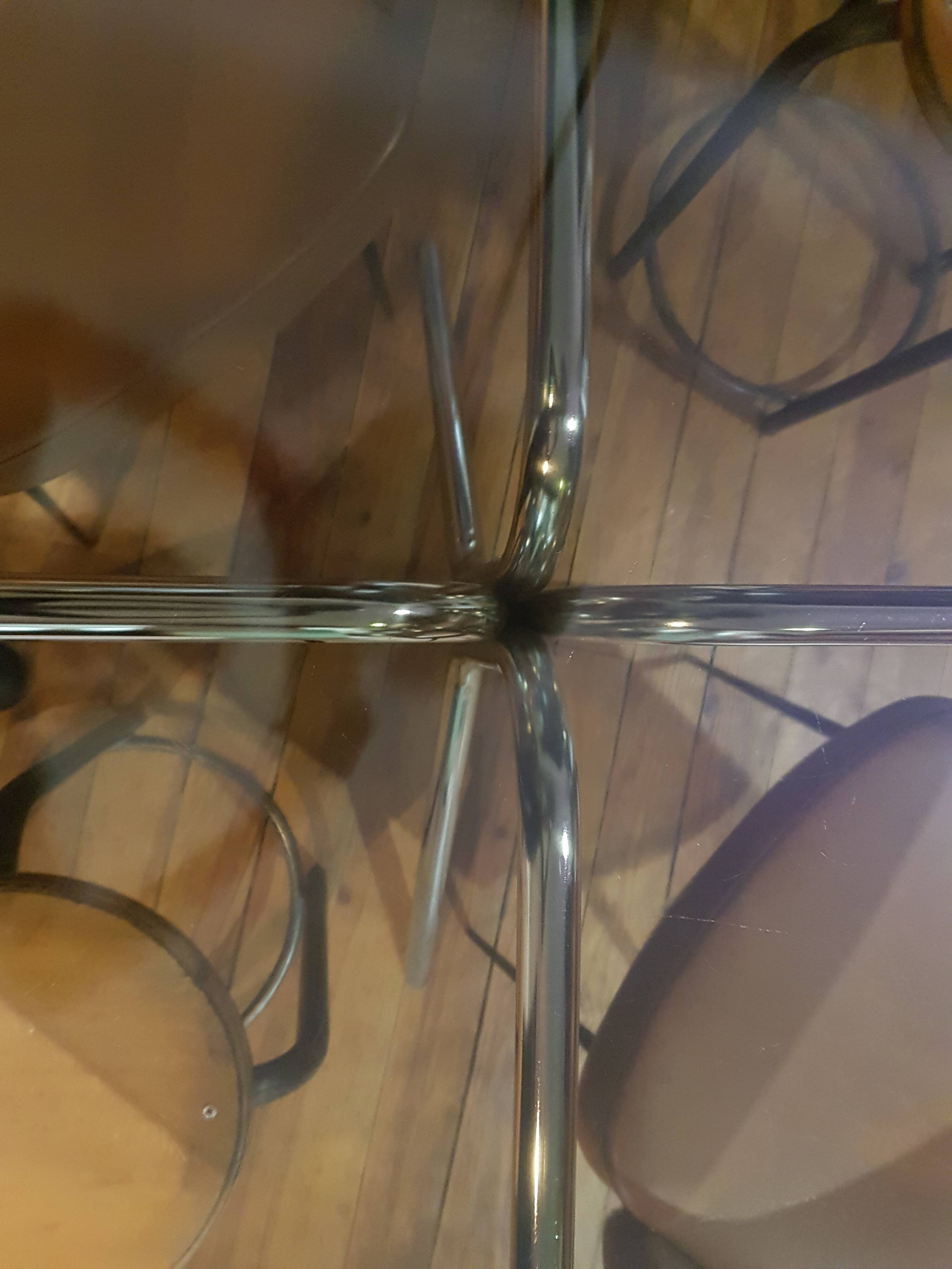 Smoked glass round table and chrome foot