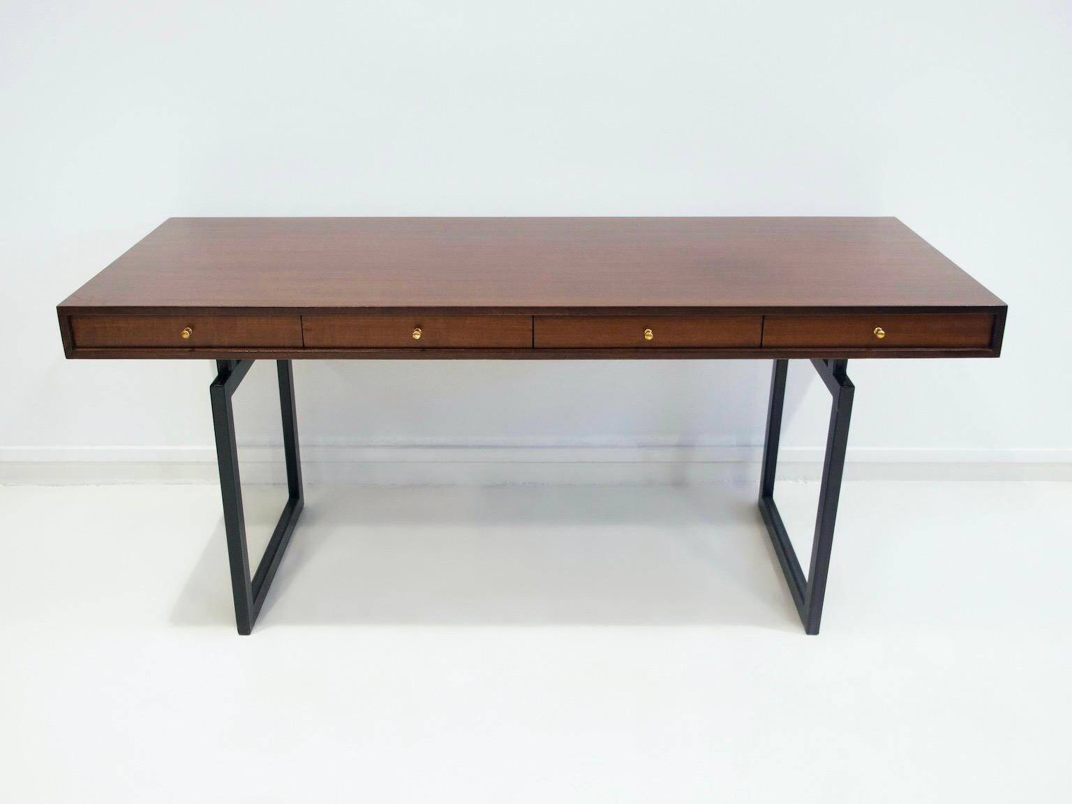 Wooden desk with drawers and black lacquered legs.