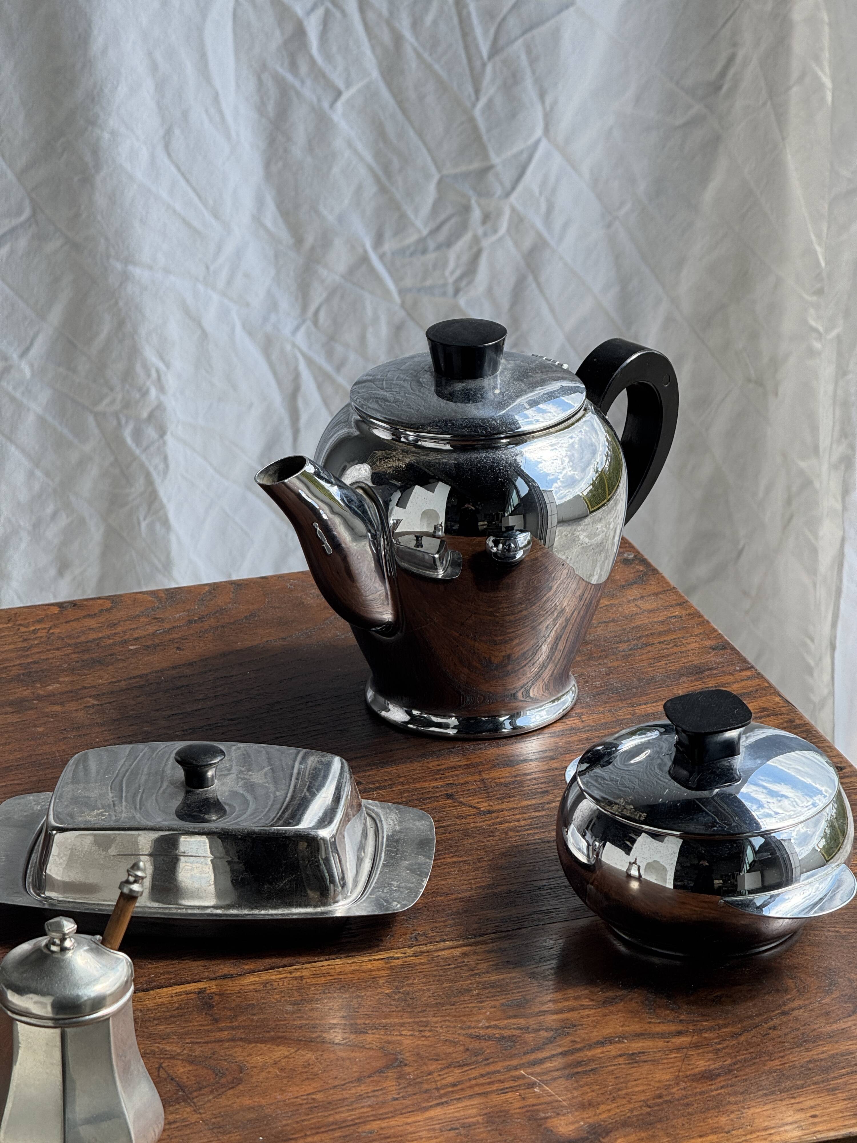 Tea set including teapot, milk jug, sugar bowl and butter dish
