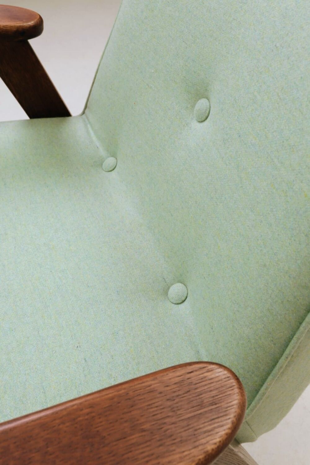 Pastel pistachio wool fabric Scandinavian armchair, oak wood.