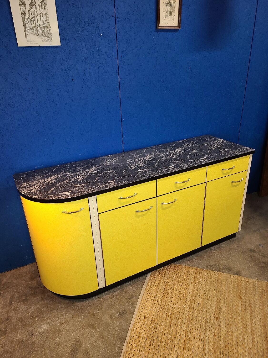 Vintage yellow sideboard, and black marble top.