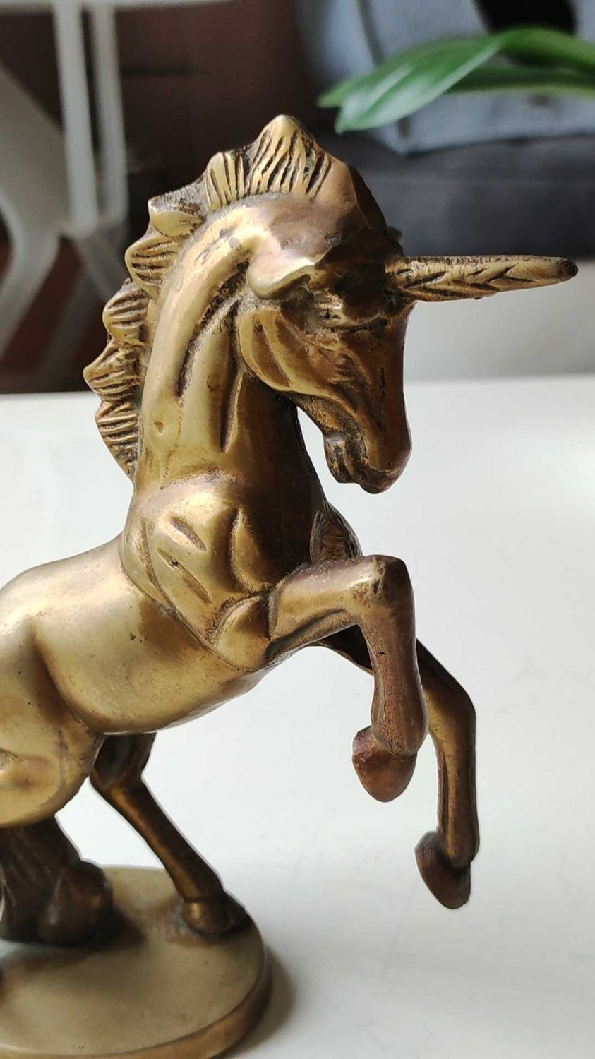 of greenhouse art deco bookends recancing unicorns. solid brass