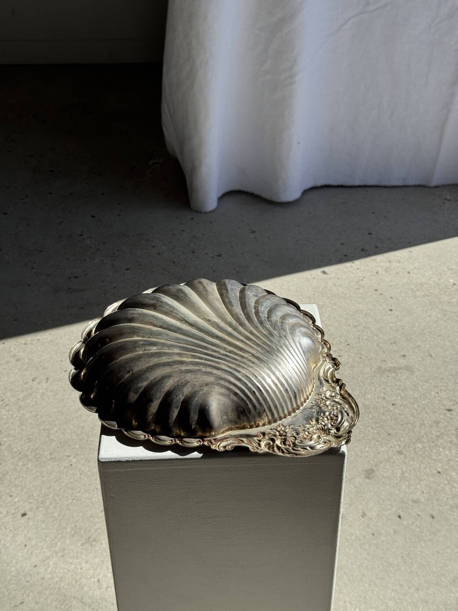 Large antique silver-plated bowl in the shape of a shell.