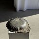 Large antique silver-plated bowl in the shape of a shell.