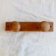 Vintage wooden coat rack with two round hooks.