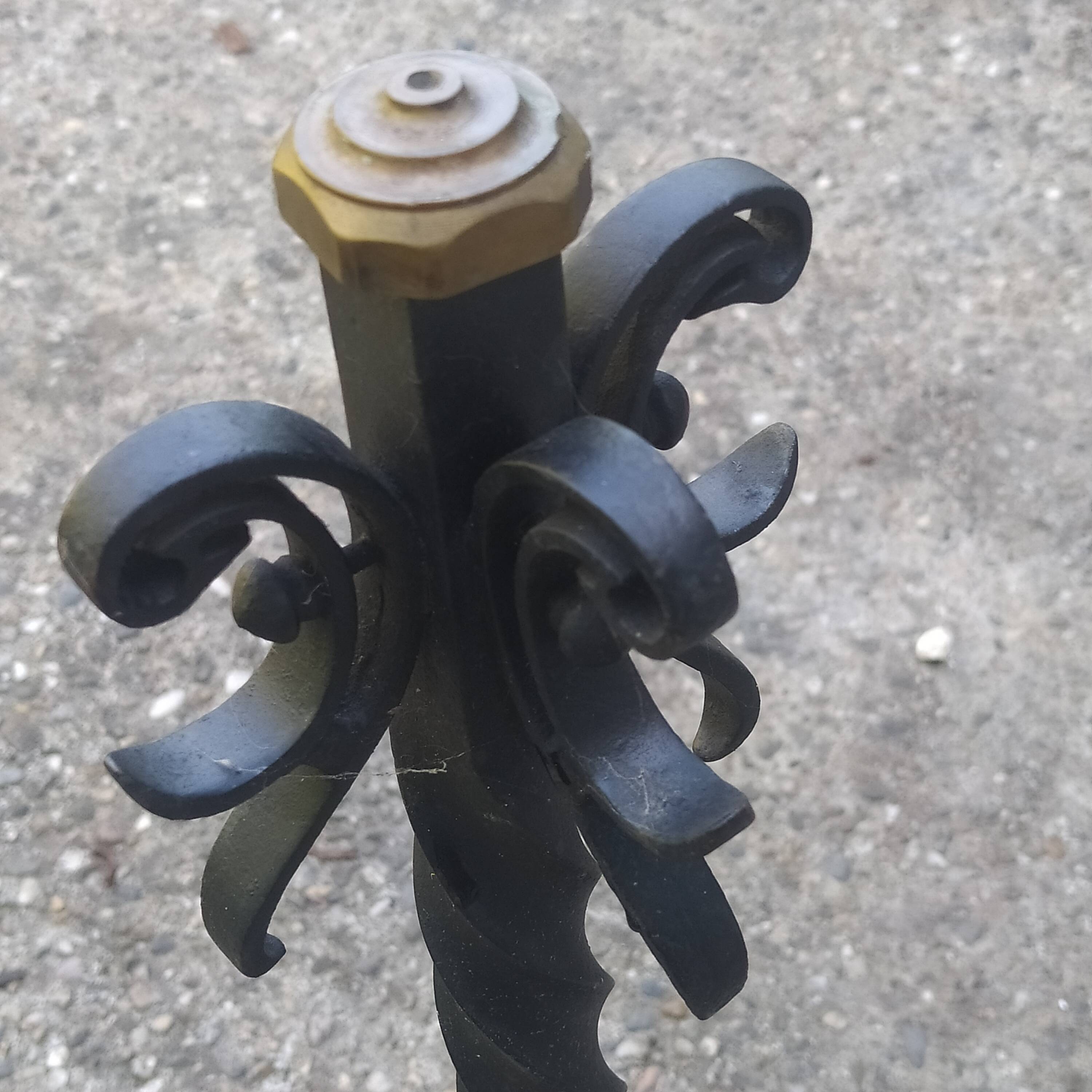 pair of large 20th century metal andirons with mascaron decoration