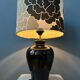 Small Space Age table lamp with a porcelain base and black and white flower shade.