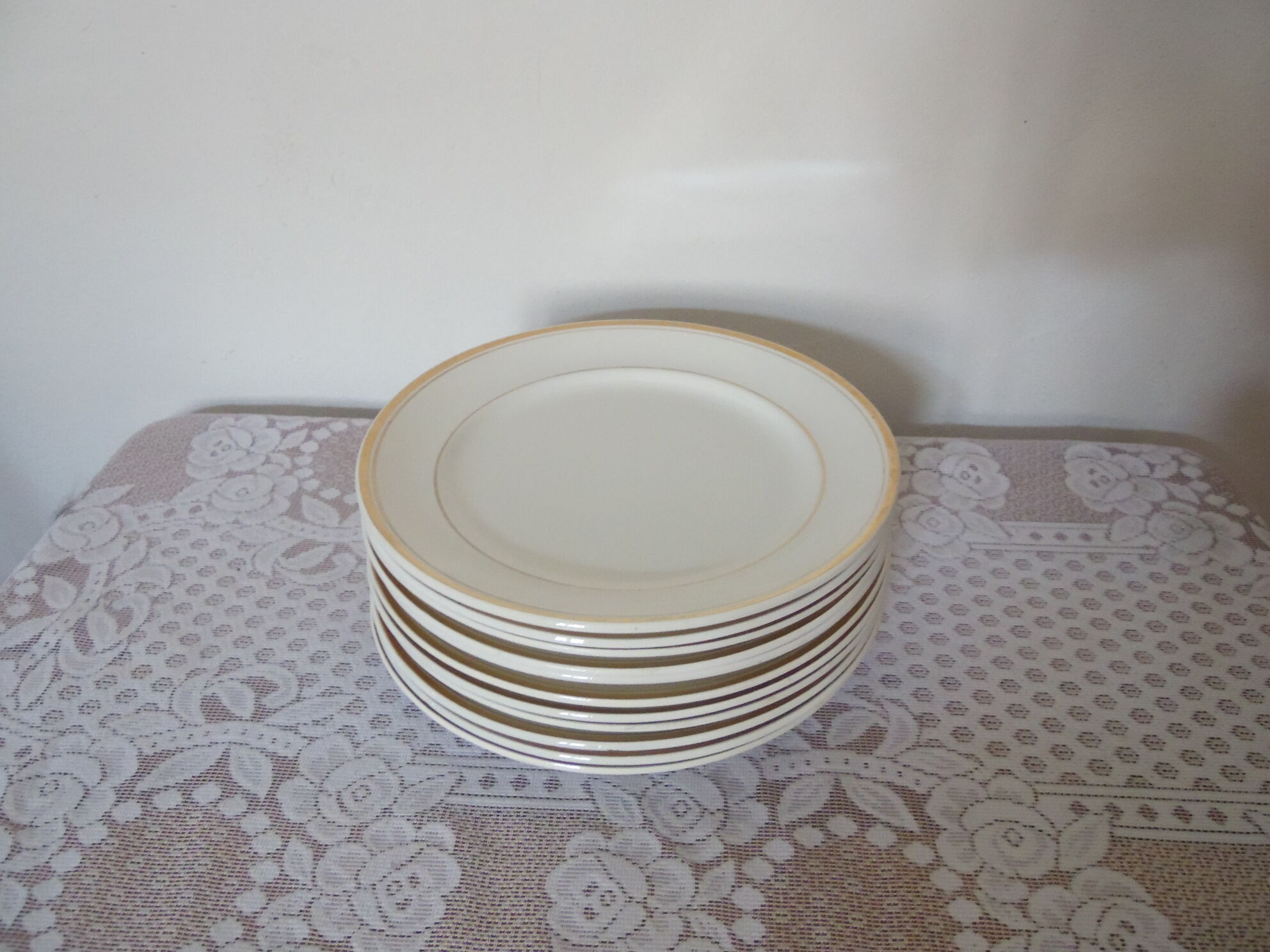 Set of 11 flat white earthenware plates with gold edging