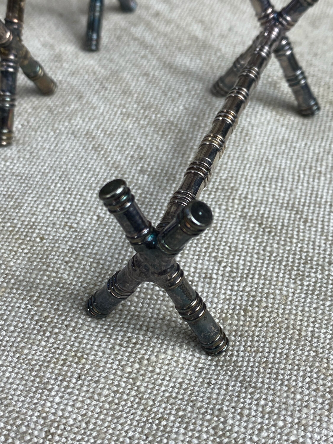 Six bamboo-patterned metal silver-plated knife rests.