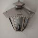 Half grey metal wall sconce and 3 windows