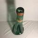 Old green molded glass bottle with rounded shape