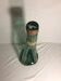 Old green molded glass bottle with rounded shape