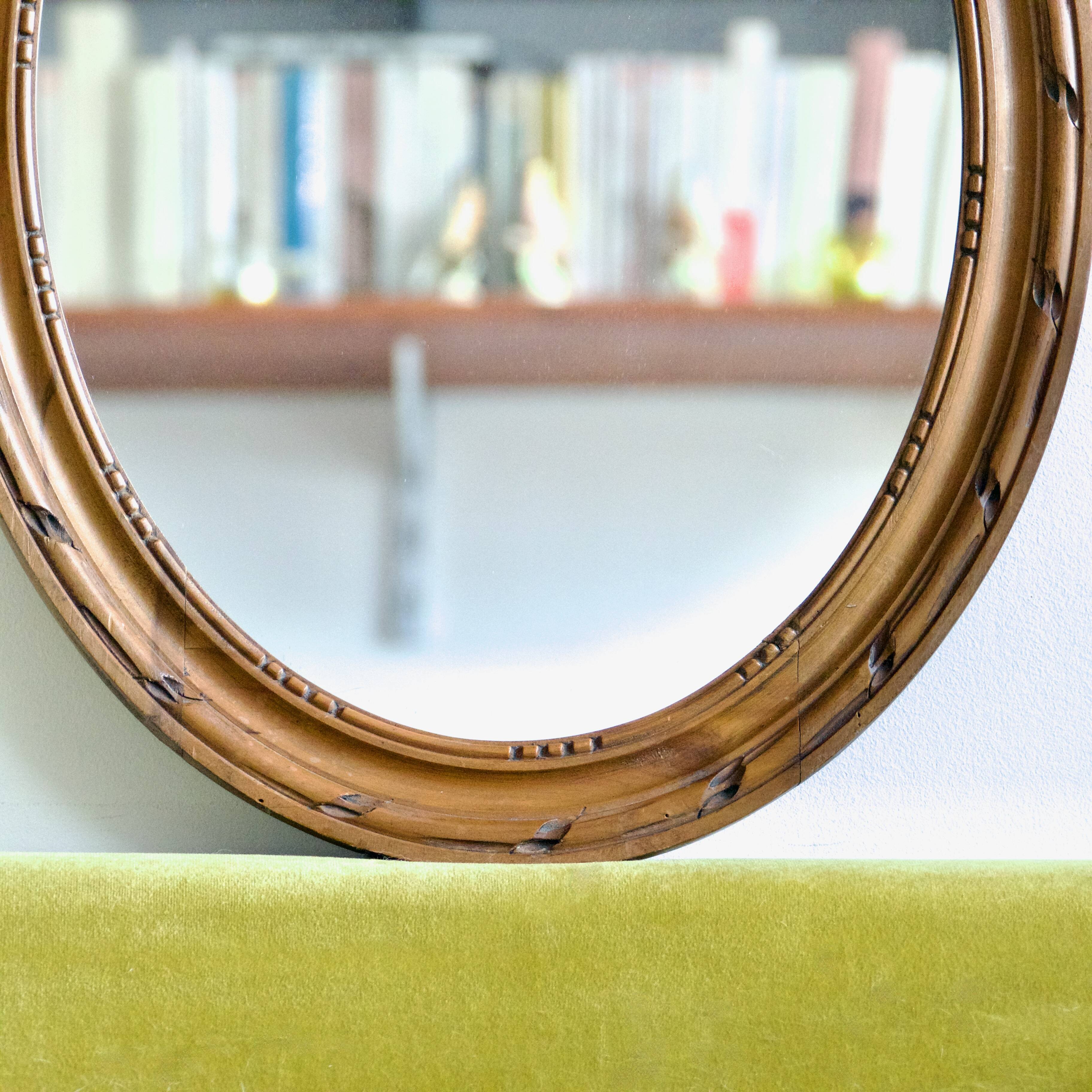 Antique oval mirror in carved wood