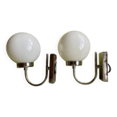 Pair of chrome metal wall lights with white glass globe.