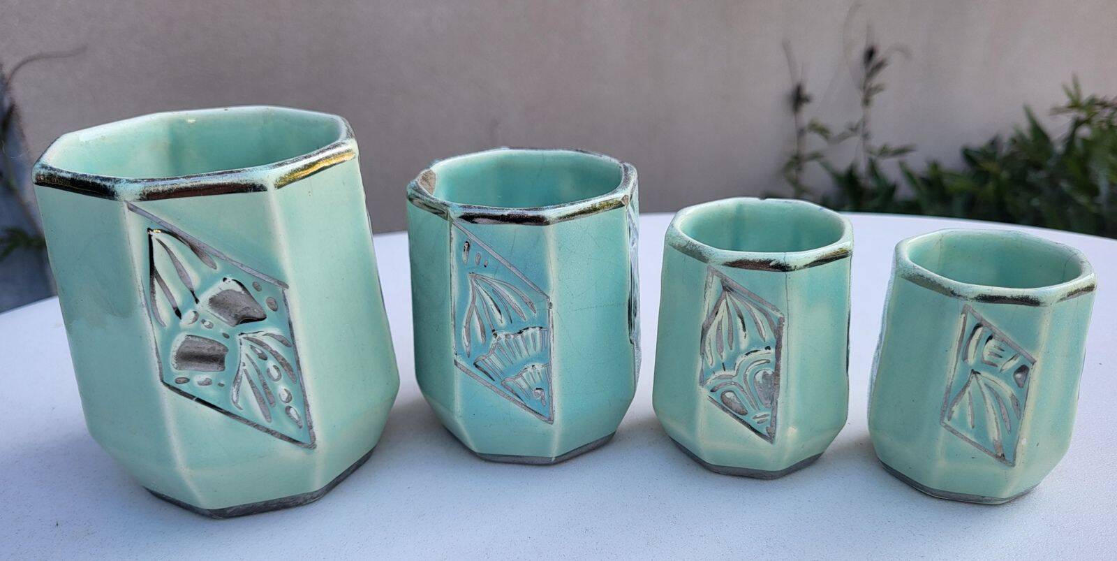 Set of 4 Art Deco celadon green and silver barbotine pots.