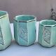Set of 4 Art Deco celadon green and silver barbotine pots.