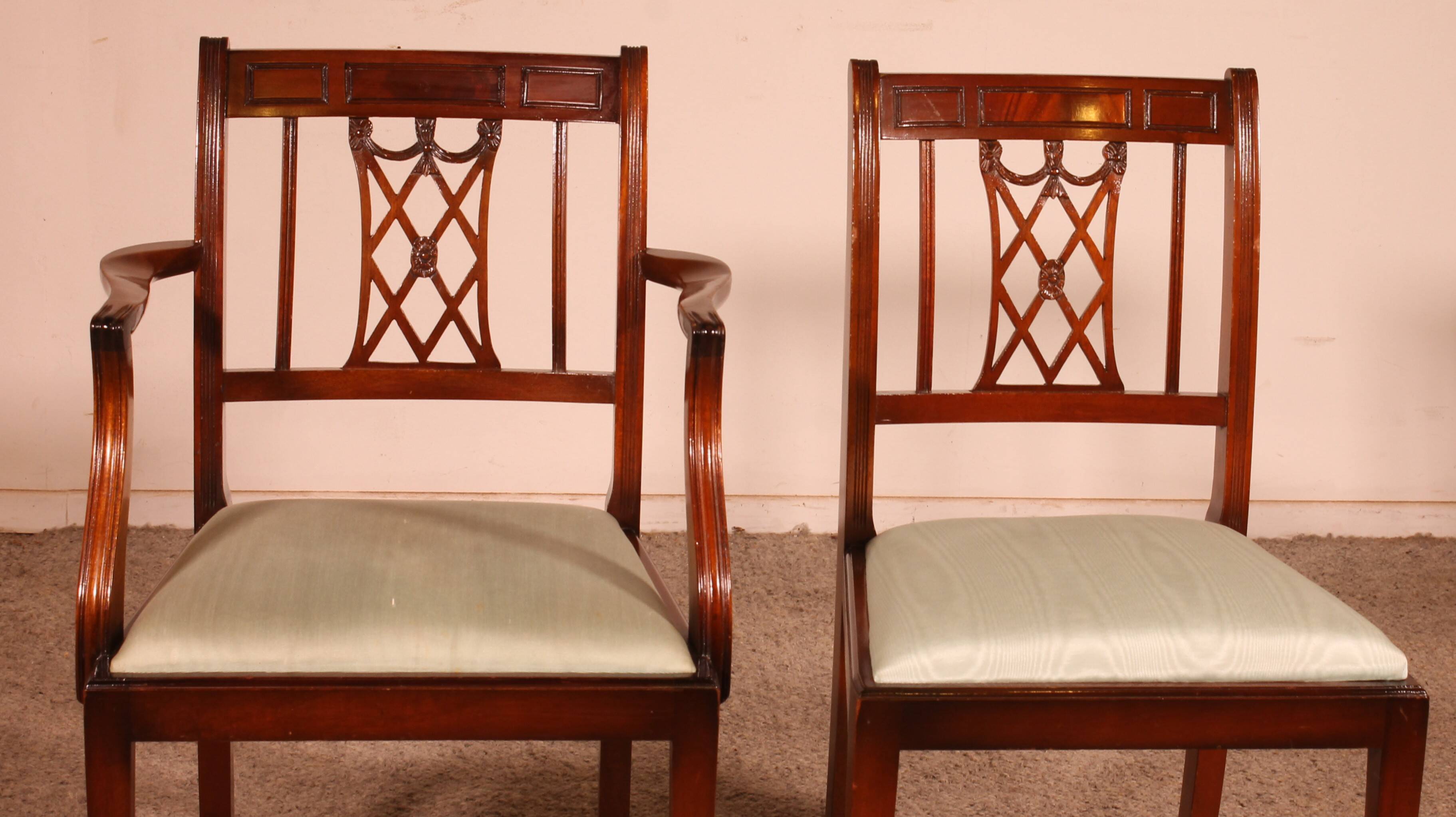 set of 10 chairs and two mahogany armchairs in Hepplewhite style