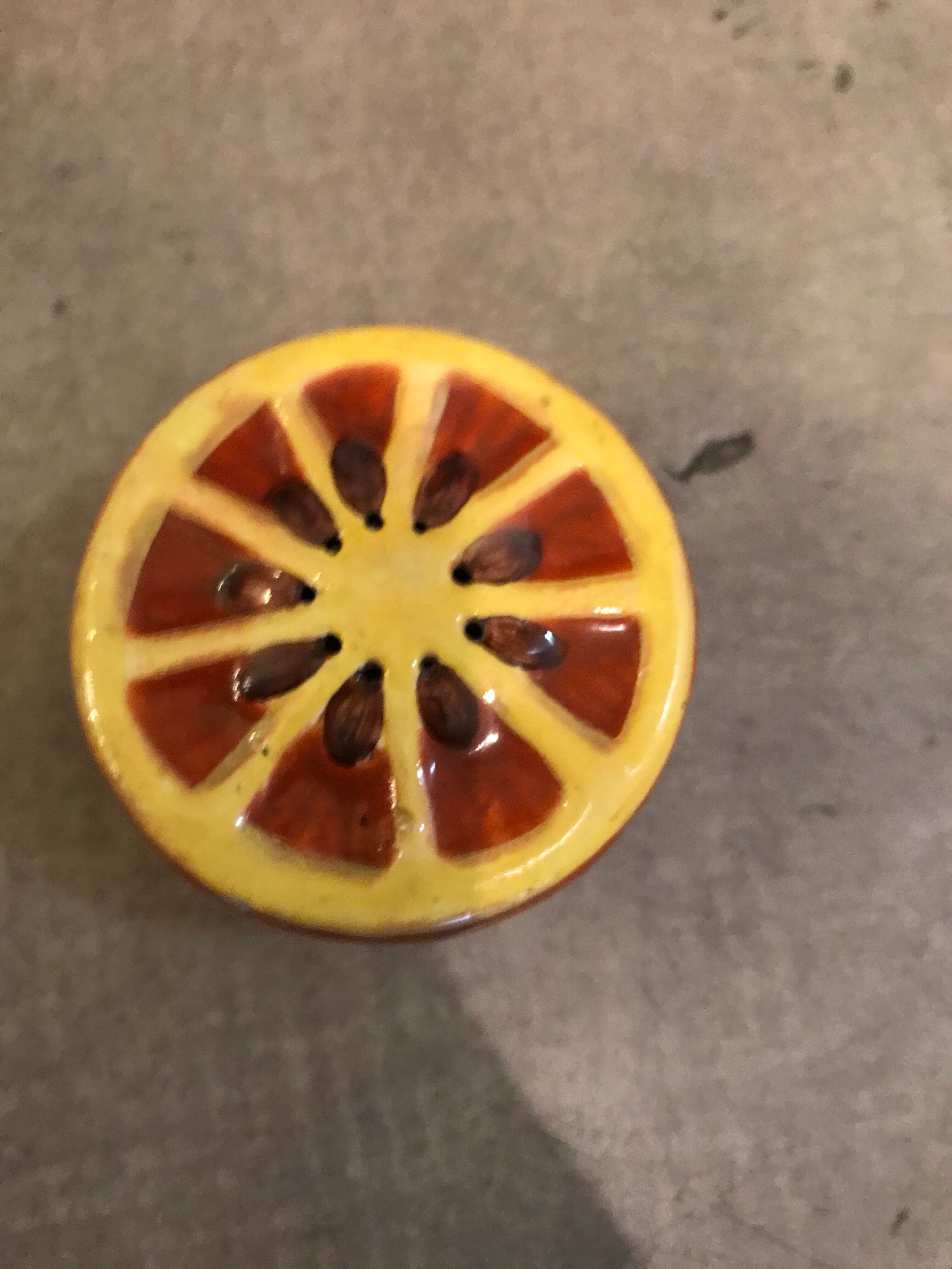 Vintage salt shaker in the shape of an orange marked ermetic