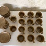Set of stoneware coffee cups with saucers