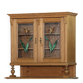 Brown pine kitchen cabinet with floral stained glass, 1920s vintage style.