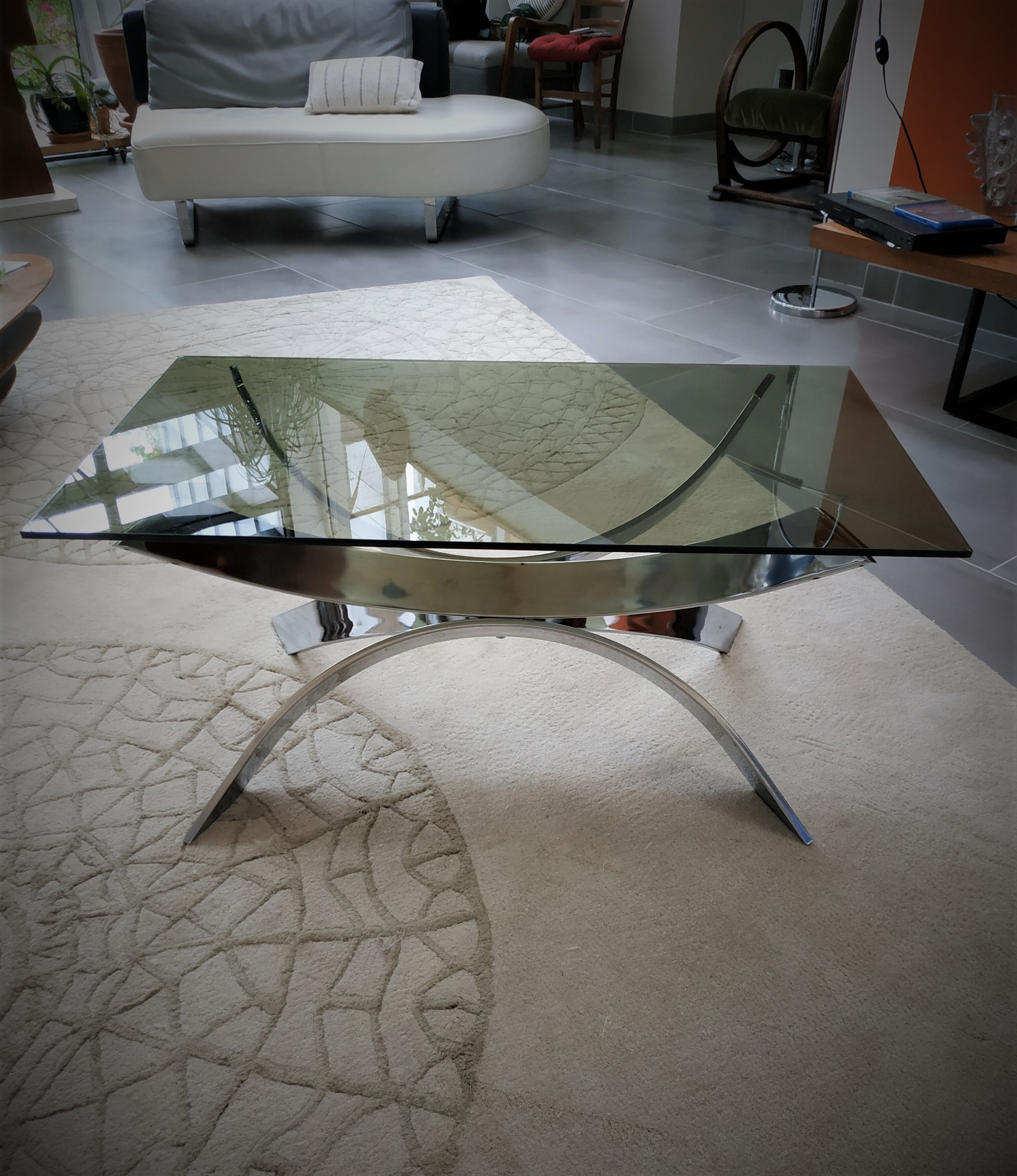 A chrome-shaped table and a 70s glass tray