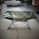A chrome-shaped table and a 70s glass tray