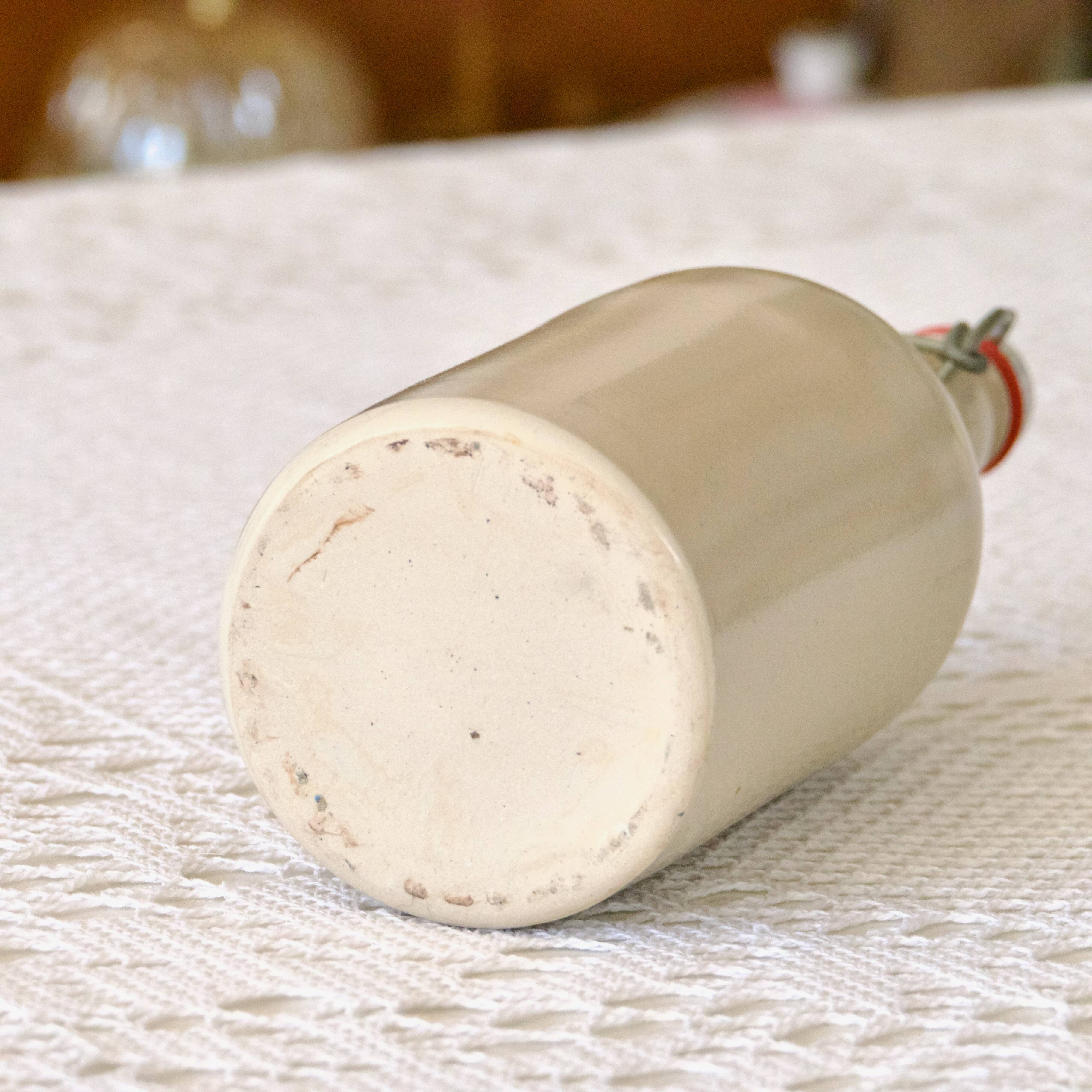 Antique enamelled stoneware beer bottle signed MKM