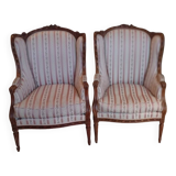 Pair of carved bergere armchairs