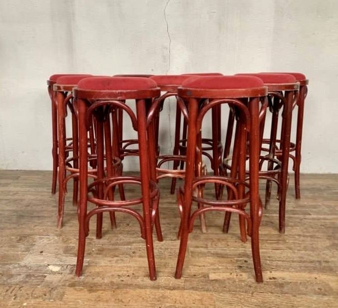 Series of 9 bistro bar stools in curved wooden restaurant sitting red fabric
