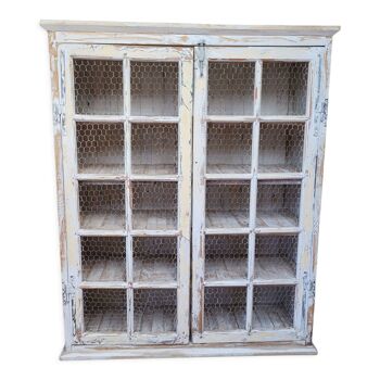 White wooden cabinet with screened doors