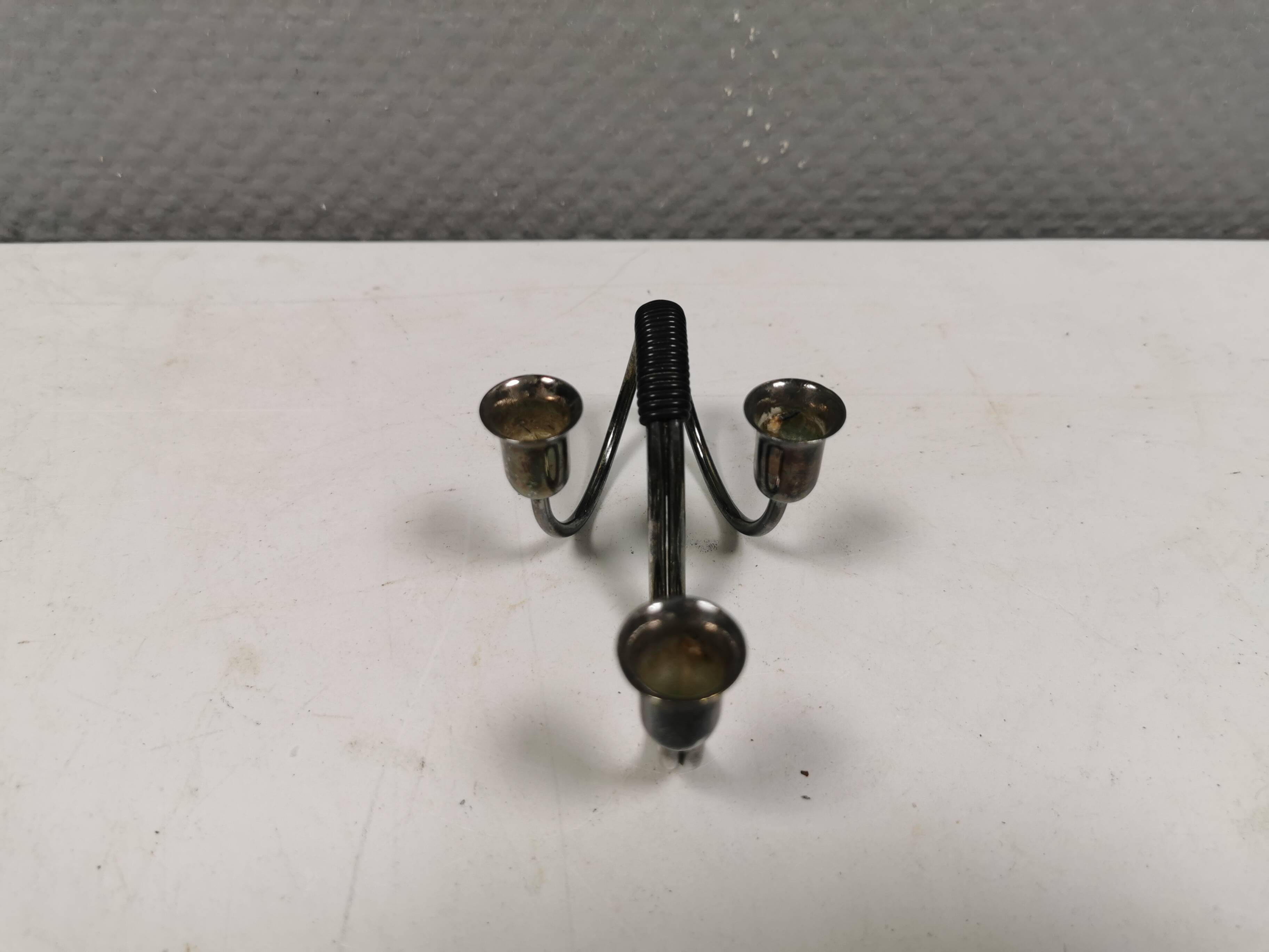 Small candle holder in tarnished silver, with place for three small candles