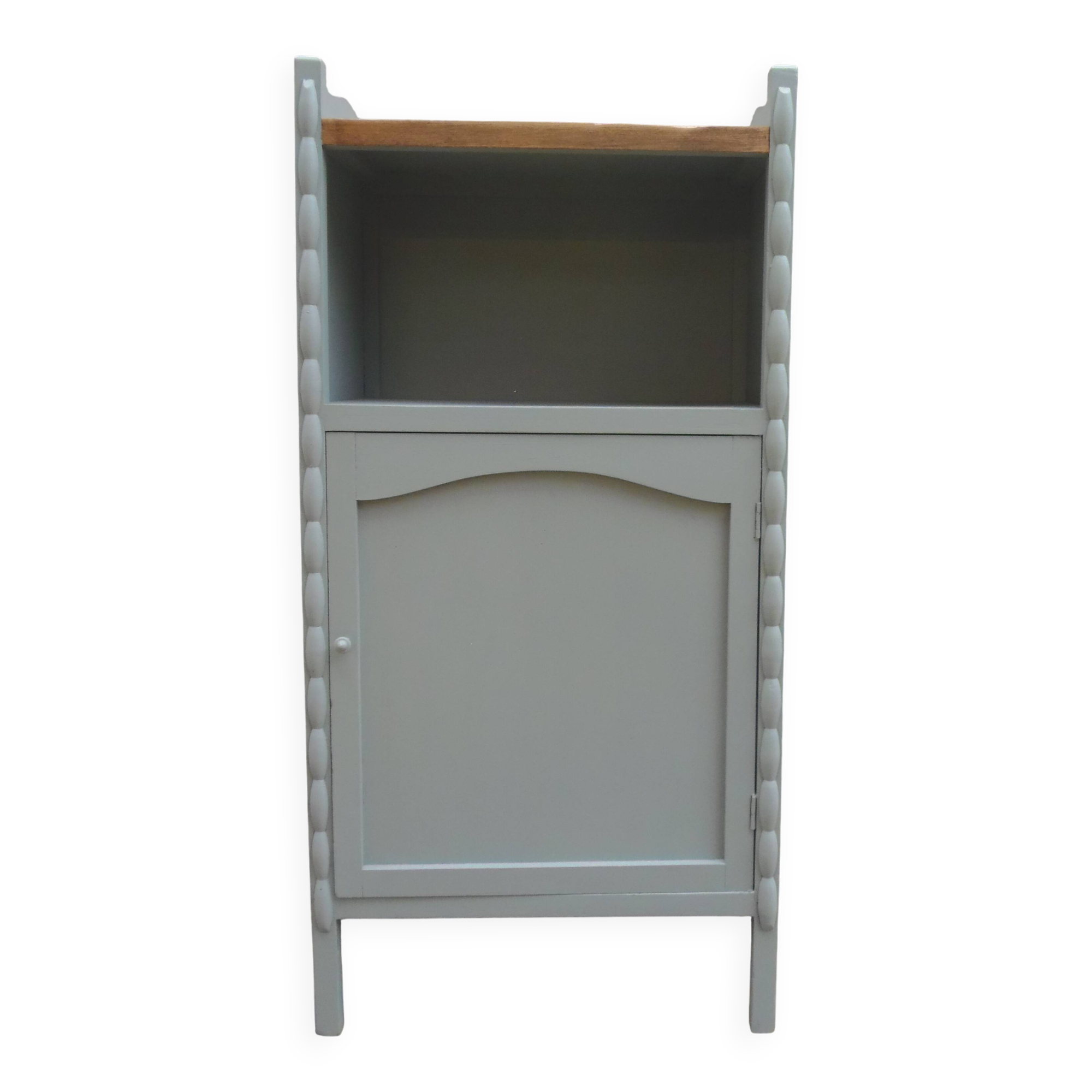 Vintage furniture of shallow depth re-enchanted in grey-green.