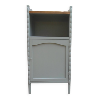 Vintage furniture of shallow depth re-enchanted in grey-green.