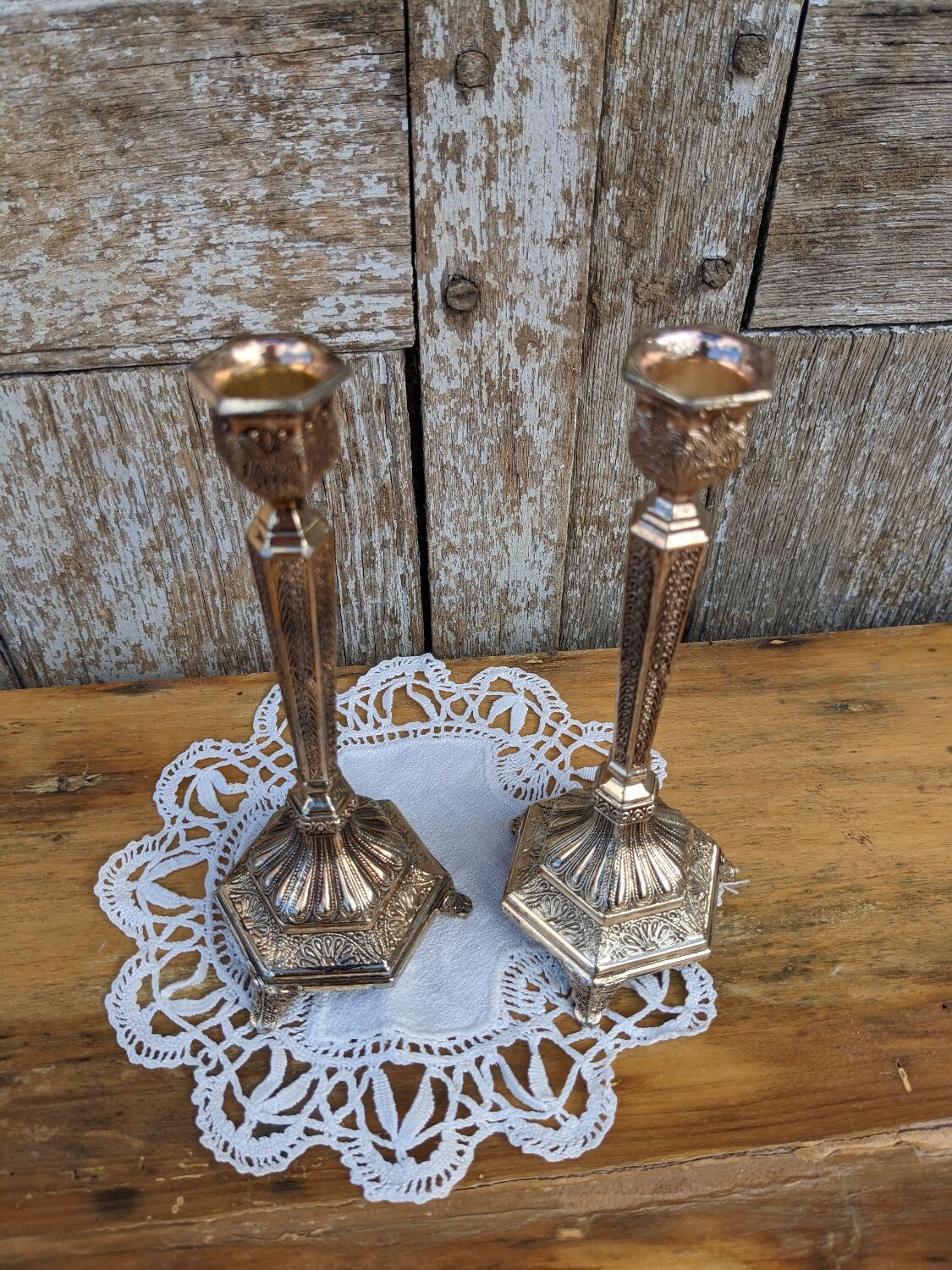 Pair of chiseled metal candle holders