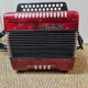 Red Aidi R accordion in his suitcase