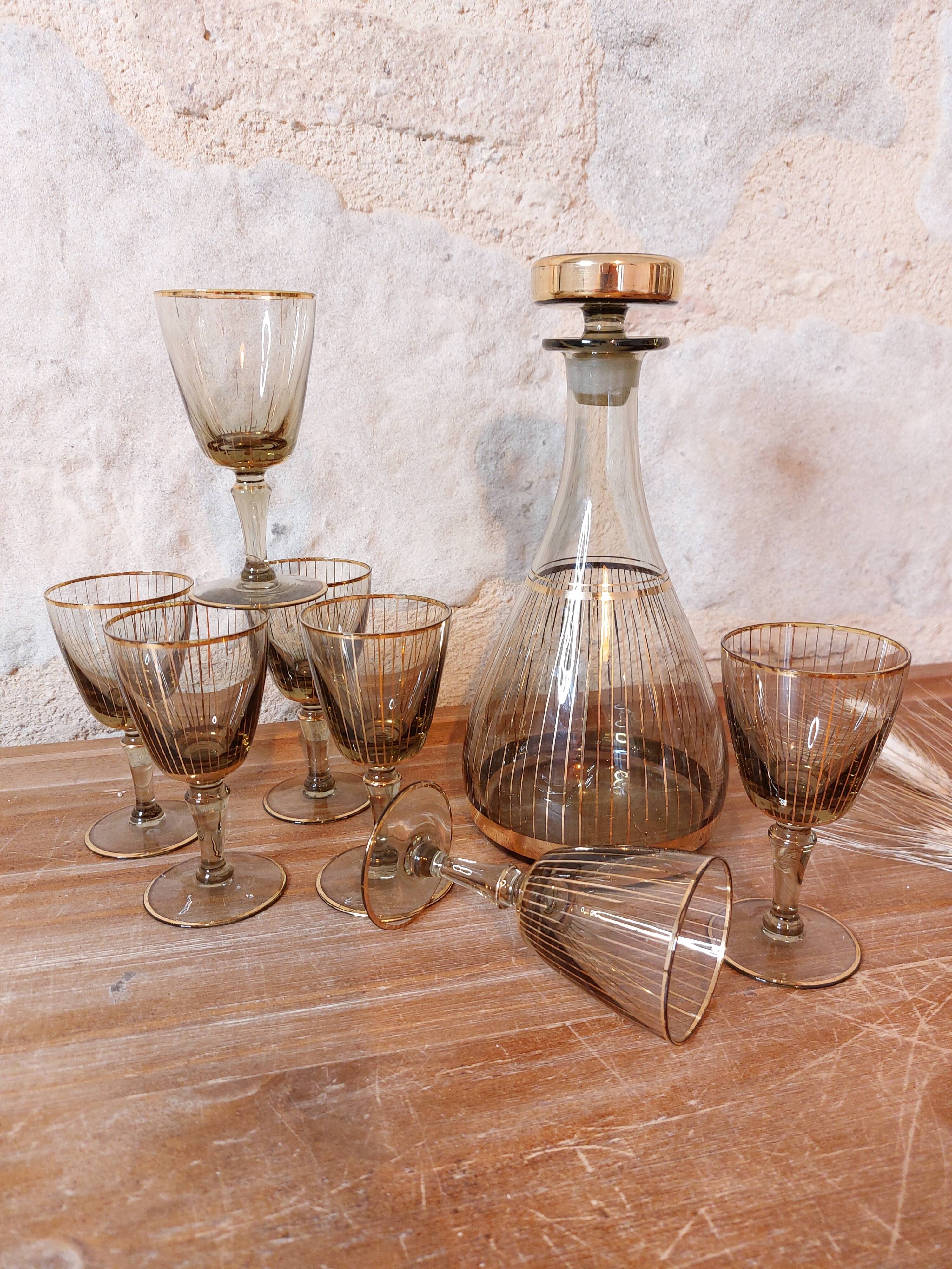 Vintage liqueur service, carafe and 7 amber brown glasses with gold edging