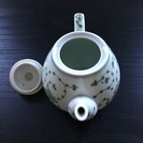 Green plant-decorated teapot