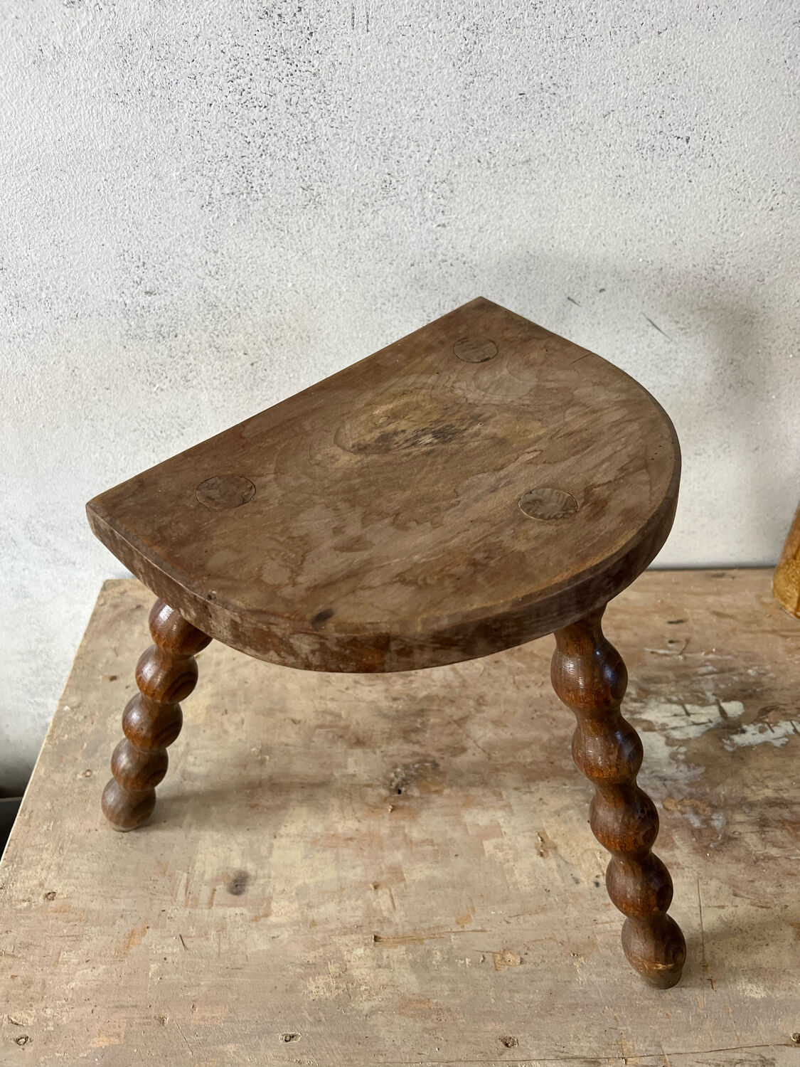 Wooden tripod farm stool