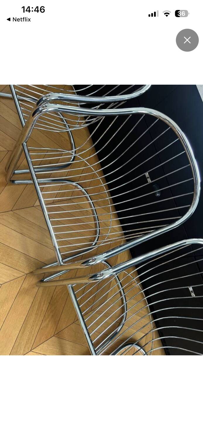 6 chrome metal chairs in the style of Gastonne Ronaldo.