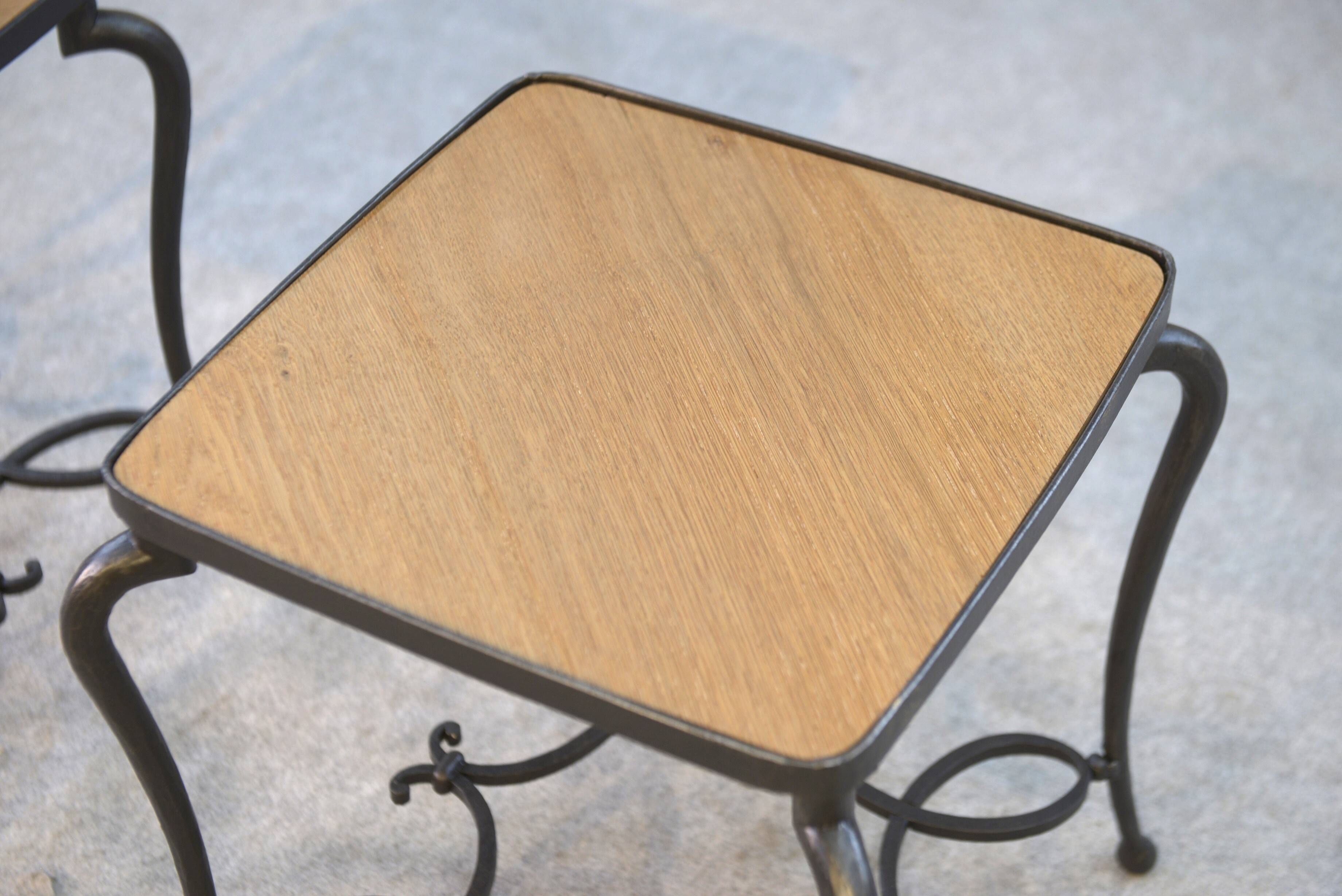 Pair of wrought iron side tables with oak tops, French work