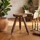 Vintage tripod stool in carved solid wood.
