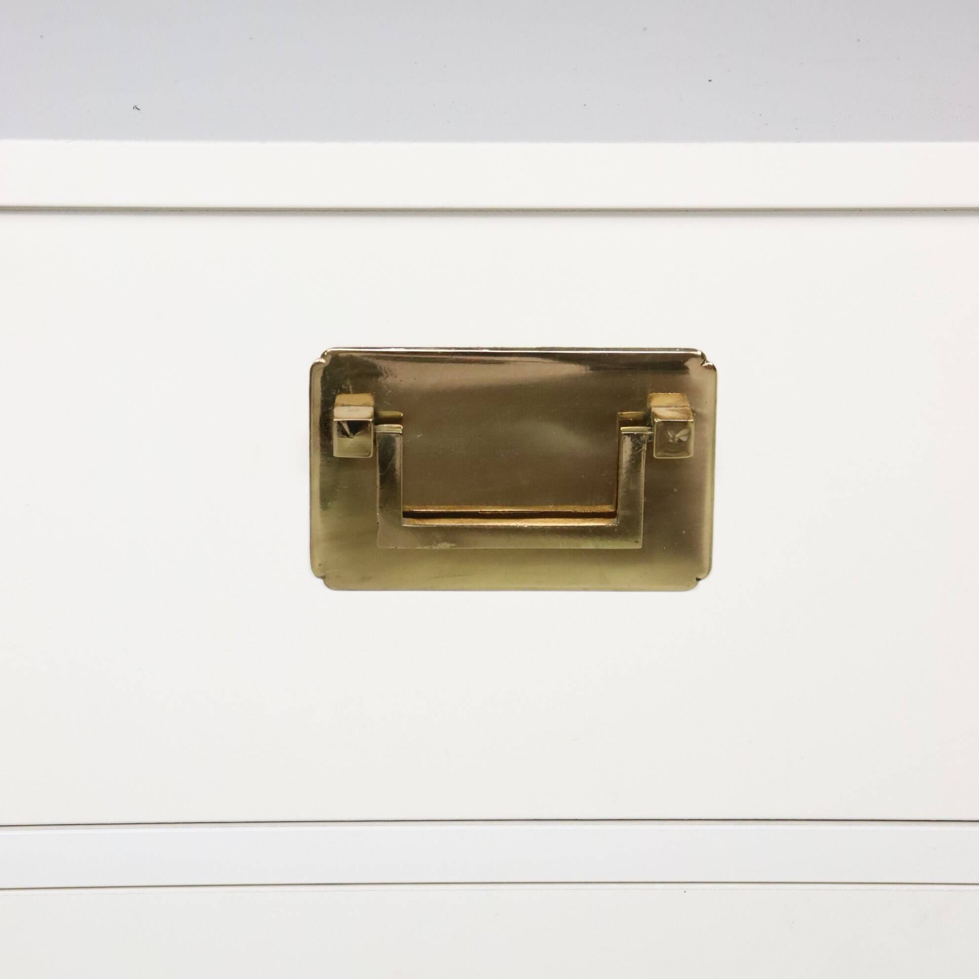 White lacquered chest of drawers and brass handles, 1970s