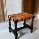 Antique turned wooden stool with woven leather.