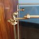 1950s bronze and tinted glass magazine rack with clawed feet