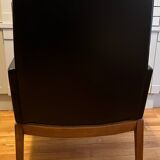 Modernist armchair in wood and black synthetic leather, circa 1960